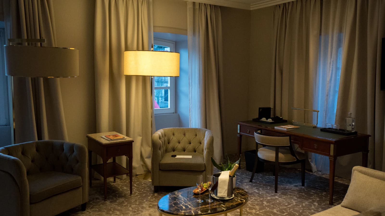 A bright guest room with a bed and seating, illustrating hotel confirmation details for travelers