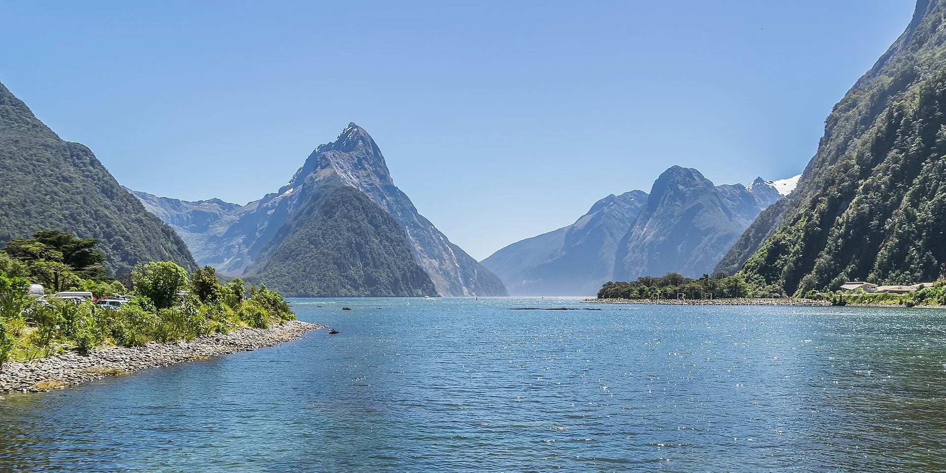 Blue water and sunlit mountains at Milford Sound