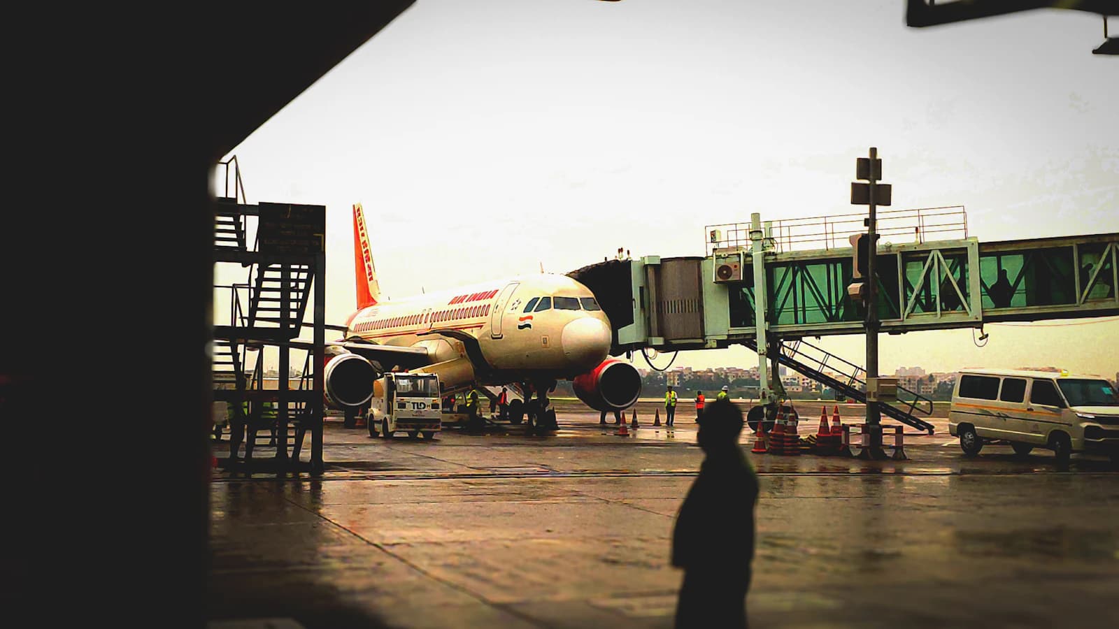 A passenger aircraft connected to an airport jet bridge before an international trip